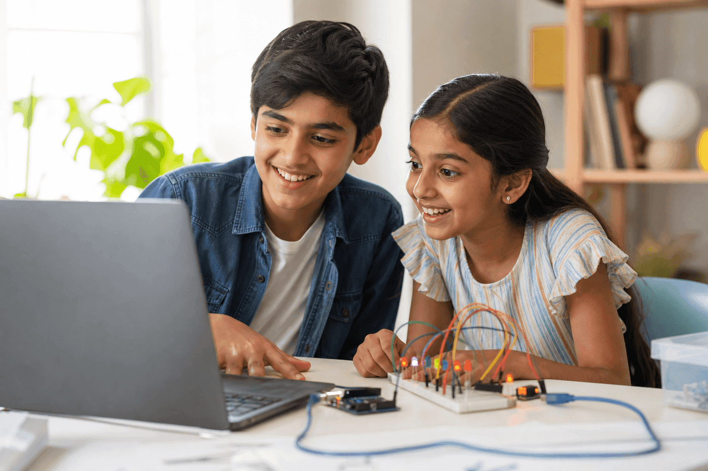 Siblings learning robotics at home with guided software